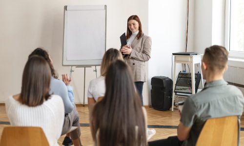 medium-shot-woman-leading-therapy-meeting